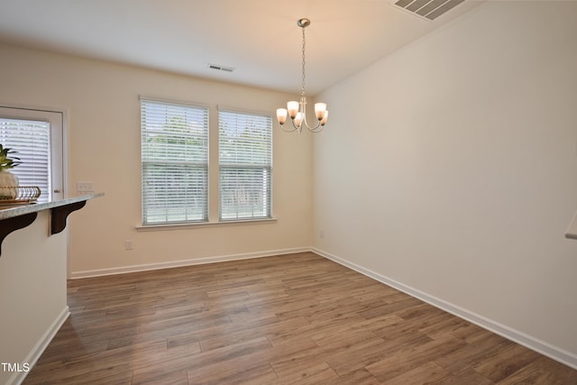 72 S Grey Abbey Dr, Clayton, NC 27527 - unfurnished dining area with a chandelier, wood finished floors, and baseboards