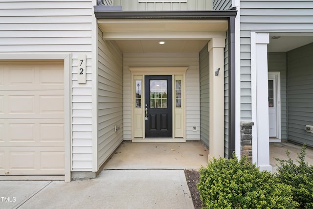 72 S Grey Abbey Dr, Clayton, NC 27527 - view of exterior entry featuring board and batten siding and an attached garage
