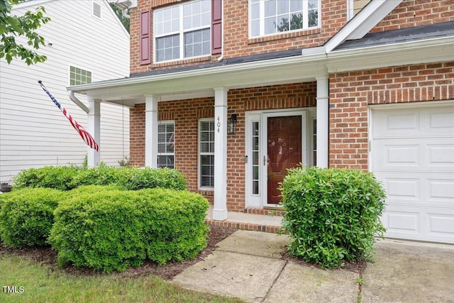 404 Straywhite Ave, Apex, NC 27539 - view of exterior entry featuring brick siding, a porch, and a garage