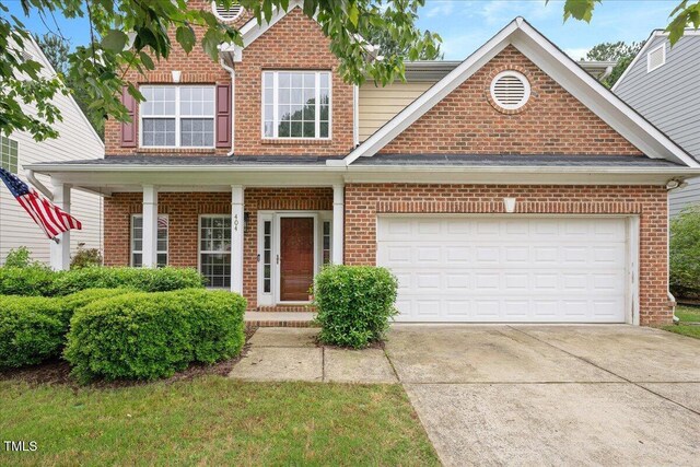404 Straywhite Ave, Apex, NC 27539 - traditional-style home featuring brick siding, driveway, and covered porch