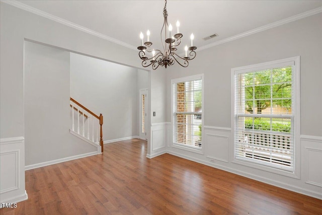 404 Straywhite Ave, Apex, NC 27539 - empty room with stairway, a chandelier, wood finished floors, ornamental molding, and wainscoting