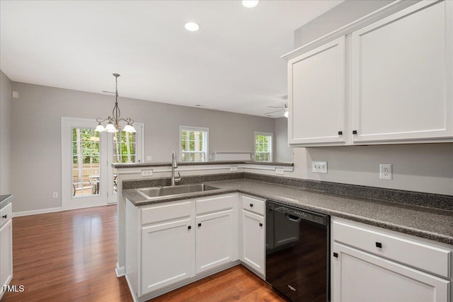 404 Straywhite Ave, Apex, NC 27539 - kitchen with black dishwasher, a sink, a peninsula, dark countertops, and recessed lighting