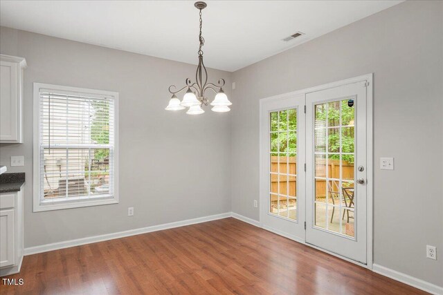 404 Straywhite Ave, Apex, NC 27539 - unfurnished dining area featuring wood finished floors, a chandelier, and baseboards