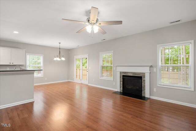 404 Straywhite Ave, Apex, NC 27539 - unfurnished living room with a fireplace, a chandelier, wood finished floors, baseboards, and recessed lighting