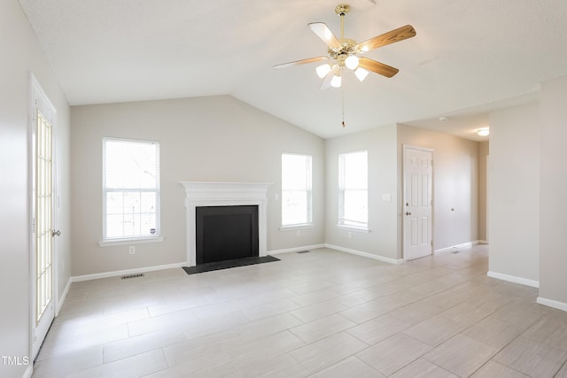 96 Landmark Dr, Angier, NC 27501 - unfurnished living room with healthy amount of natural light, lofted ceiling, ceiling fan, a fireplace with flush hearth, and baseboards