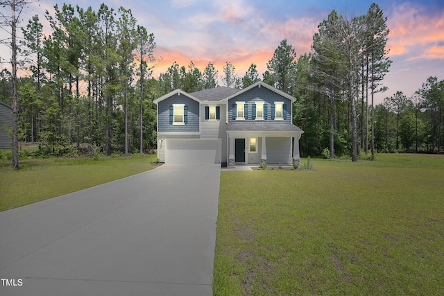 124 Teagarden Ct, Sanford, NC 27332 - traditional home featuring a garage, driveway, a porch, and a front yard