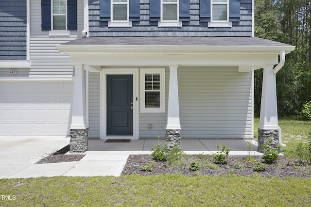 124 Teagarden Ct, Sanford, NC 27332 - view of exterior entry featuring a porch, an attached garage, and a shingled roof