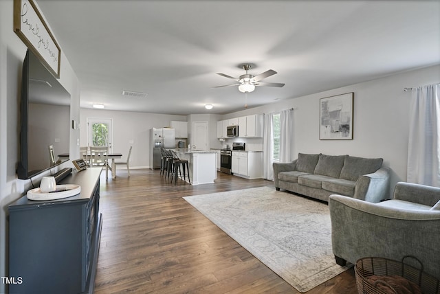 124 Teagarden Ct, Sanford, NC 27332 - living room featuring dark wood-style flooring, ceiling fan, plenty of natural light, and baseboards