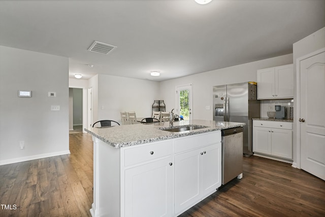 124 Teagarden Ct, Sanford, NC 27332 - kitchen with appliances with stainless steel finishes, a sink, a center island with sink, and dark wood-type flooring