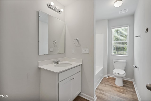 124 Teagarden Ct, Sanford, NC 27332 - full bathroom featuring wood finished floors, vanity, toilet, baseboards, and tub / shower combination