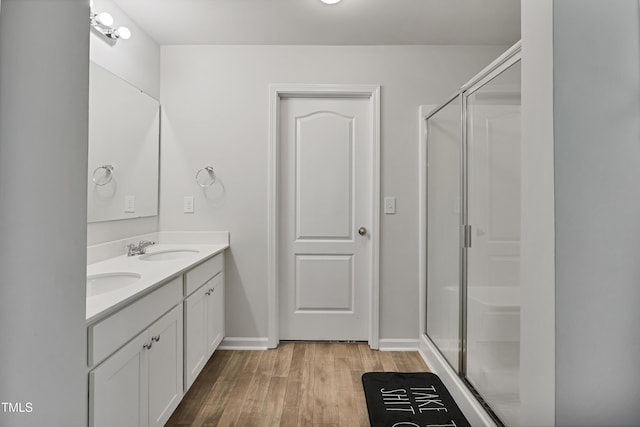 124 Teagarden Ct, Sanford, NC 27332 - full bath with double vanity, wood finished floors, a shower stall, and baseboards