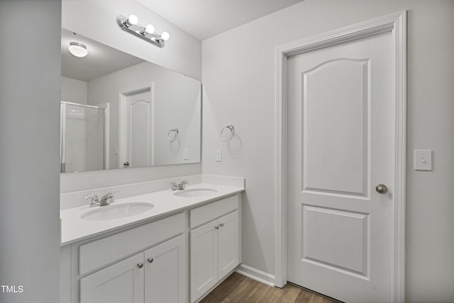 124 Teagarden Ct, Sanford, NC 27332 - full bathroom featuring double vanity, a shower with door, wood finished floors, and baseboards