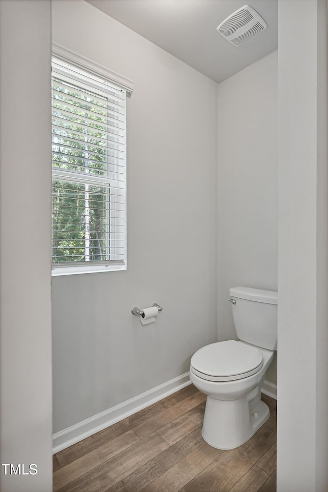 124 Teagarden Ct, Sanford, NC 27332 - bathroom featuring wood finished floors, toilet, baseboards, and healthy amount of natural light