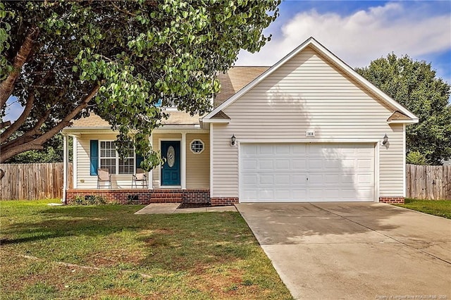 1414 Seabiscuit Dr, Parkton, NC 28371 - view of front of home featuring an attached garage, driveway, a porch, and roof with shingles