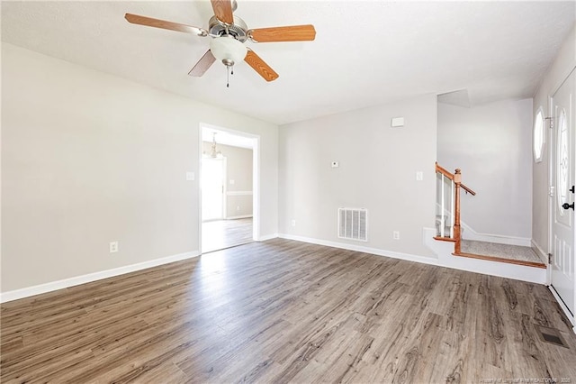 1414 Seabiscuit Dr, Parkton, NC 28371 - unfurnished room with wood finished floors, stairway, baseboards, and a ceiling fan