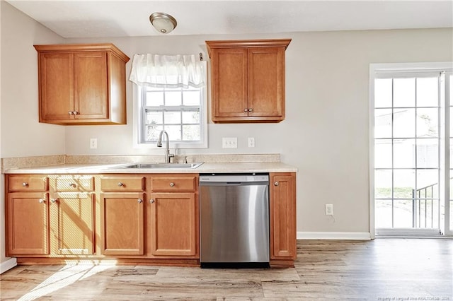 1414 Seabiscuit Dr, Parkton, NC 28371 - kitchen with dishwasher, a sink, light wood-type flooring, and light countertops