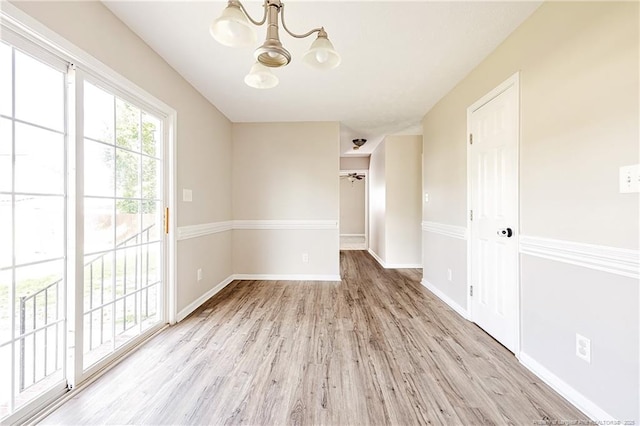 1414 Seabiscuit Dr, Parkton, NC 28371 - empty room with a chandelier, light wood finished floors, and baseboards