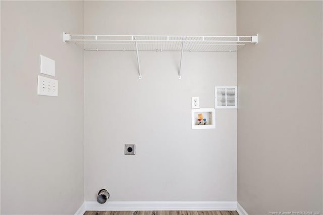 1414 Seabiscuit Dr, Parkton, NC 28371 - laundry area featuring washer hookup, hookup for an electric dryer, wood finished floors, and baseboards