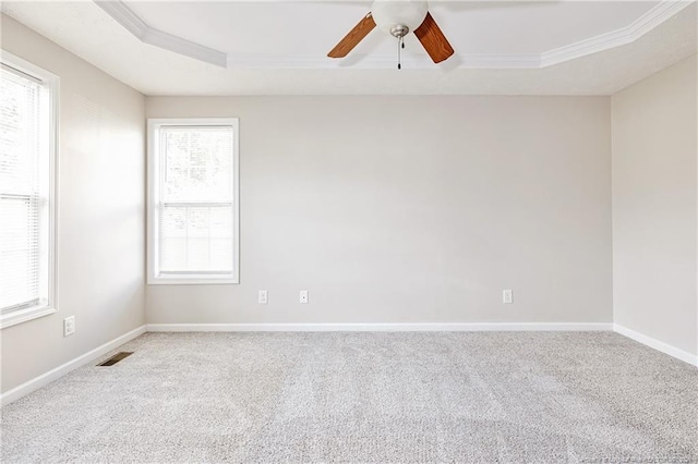 1414 Seabiscuit Dr, Parkton, NC 28371 - spare room featuring ornamental molding, carpet flooring, ceiling fan, a raised ceiling, and baseboards