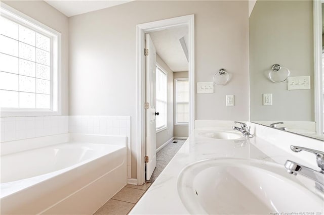 1414 Seabiscuit Dr, Parkton, NC 28371 - full bath with a garden tub, tile patterned floors, double vanity, and plenty of natural light