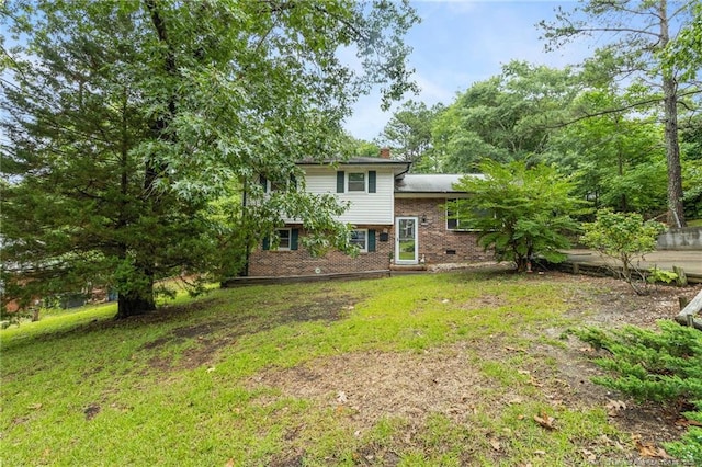 830 Edenwood Dr, Fayetteville, NC 28303 - rear view of house featuring brick siding, a chimney, and a lawn
