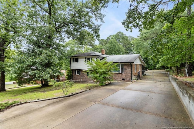 830 Edenwood Dr, Fayetteville, NC 28303 - tri-level home featuring driveway, brick siding, a chimney, and crawl space