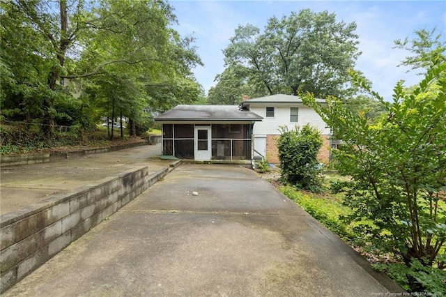 830 Edenwood Dr, Fayetteville, NC 28303 - rear view of property with a sunroom and concrete driveway