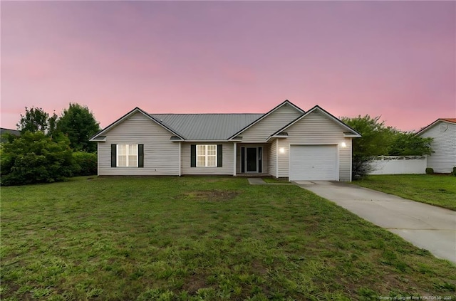 225 Northwoods Dr, Raeford, NC 28376 - single story home with driveway, a garage, and metal roof
