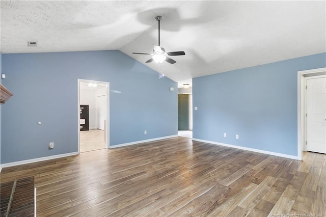 225 Northwoods Dr, Raeford, NC 28376 - unfurnished living room with ceiling fan, wood finished floors, vaulted ceiling, and baseboards
