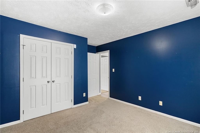 225 Northwoods Dr, Raeford, NC 28376 - unfurnished bedroom featuring baseboards, carpet, a textured ceiling, and a closet