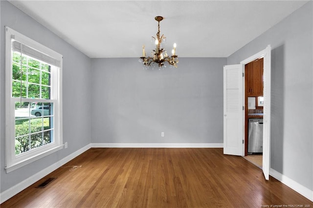 500 Cecil St, Fayetteville, NC 28312 - unfurnished room featuring a chandelier, wood finished floors, and baseboards