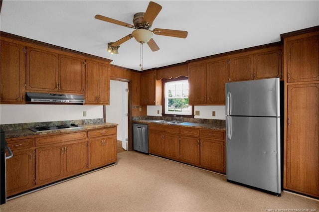 500 Cecil St, Fayetteville, NC 28312 - kitchen featuring appliances with stainless steel finishes, under cabinet range hood, a sink, and brown cabinetry
