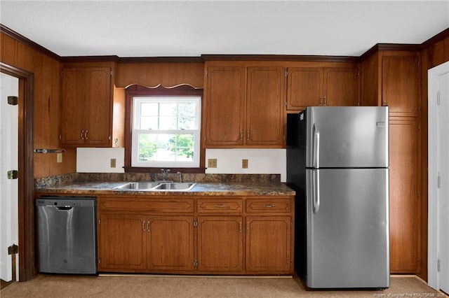 500 Cecil St, Fayetteville, NC 28312 - kitchen featuring stainless steel appliances, a sink, brown cabinets, and dark countertops
