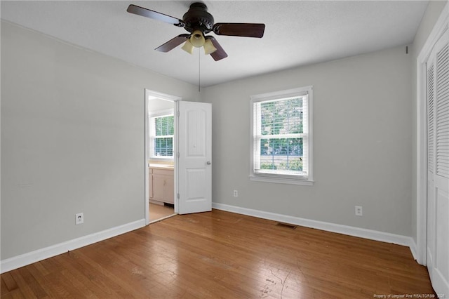 500 Cecil St, Fayetteville, NC 28312 - unfurnished bedroom with baseboards, light wood-style flooring, and connected bathroom