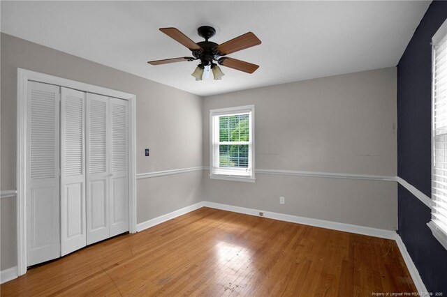 500 Cecil St, Fayetteville, NC 28312 - unfurnished bedroom with baseboards, wood finished floors, a closet, and a ceiling fan
