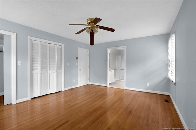 500 Cecil St, Fayetteville, NC 28312 - unfurnished bedroom with baseboards, wood finished floors, ceiling fan, and ensuite bathroom