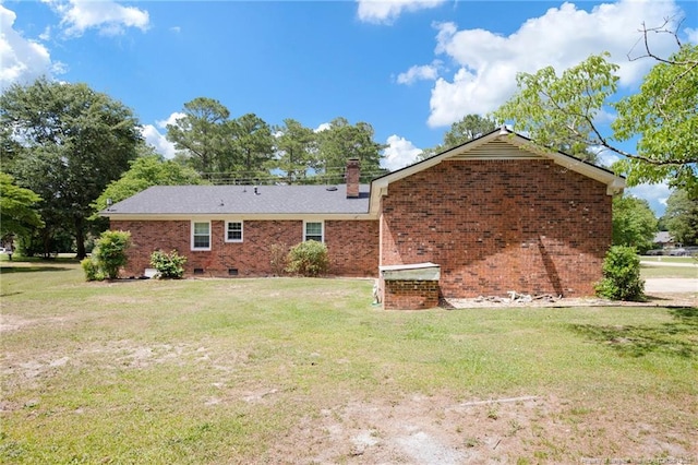 500 Cecil St, Fayetteville, NC 28312 - rear view of house with brick siding, a yard, and a chimney