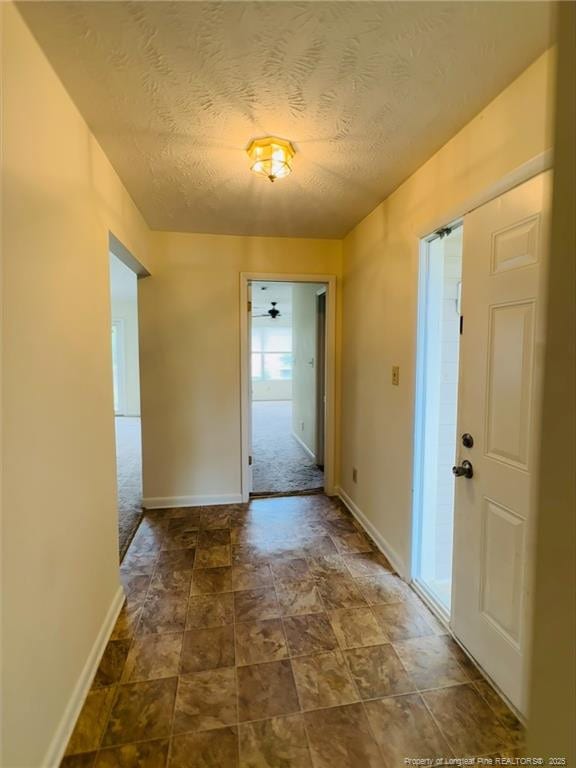 661 Bartons Landing Pl Unit 9, Fayetteville, NC 28314 - entryway featuring a textured ceiling, baseboards, and dark stone finish flooring