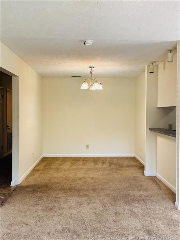 661 Bartons Landing Pl Unit 9, Fayetteville, NC 28314 - spare room with light colored carpet, a chandelier, baseboards, and a smoke detector