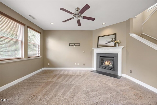 132 Ryder Cup Cir, Raleigh, NC 27603 - unfurnished living room with carpet, a ceiling fan, a fireplace with flush hearth, and recessed lighting