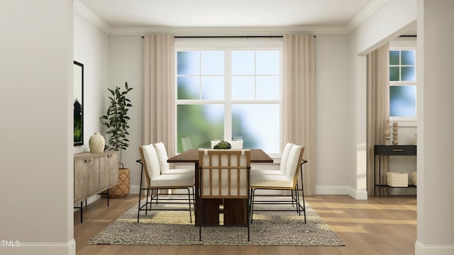 945 Cassa Clubhouse Way, Knightdale, NC 27545 - dining space featuring light wood-style flooring, plenty of natural light, crown molding, and baseboards