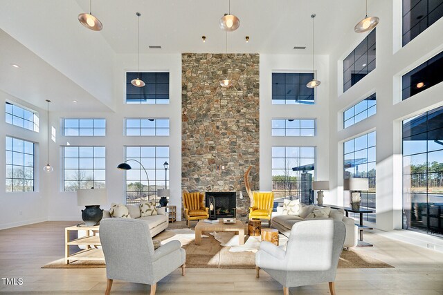 945 Cassa Clubhouse Way, Knightdale, NC 27545 - living area featuring a towering ceiling, wood finished floors, and a fireplace