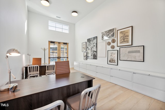 945 Cassa Clubhouse Way, Knightdale, NC 27545 - office space featuring light wood-style flooring, french doors, and a towering ceiling