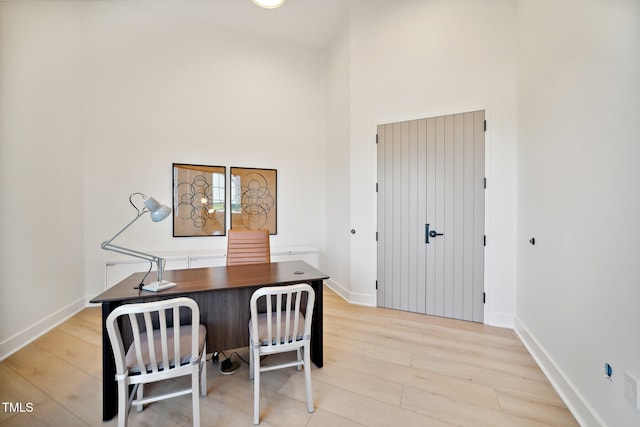 945 Cassa Clubhouse Way, Knightdale, NC 27545 - home office with light wood finished floors, baseboards, and a high ceiling