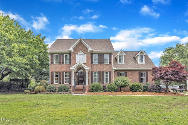 4620 Gomar Ln, Fuquay Varina, NC 27526 - view of front facade with brick siding, a front yard, and roof with shingles