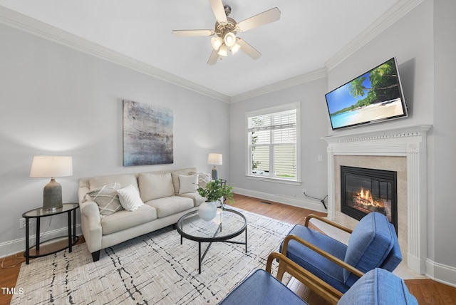 106 Painted Turtle Ln, Cary, NC 27519 - living room with a premium fireplace, baseboards, ornamental molding, wood finished floors, and a ceiling fan