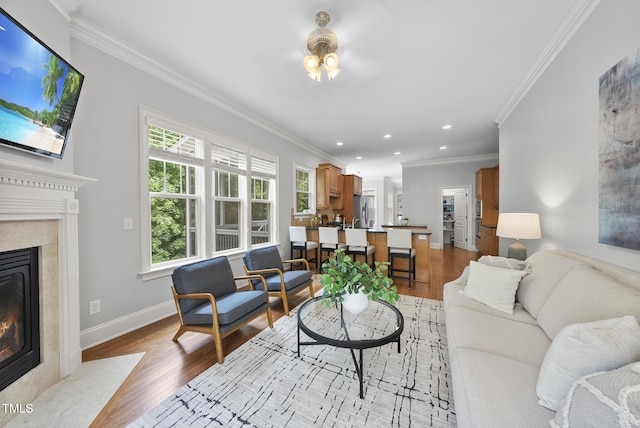 106 Painted Turtle Ln, Cary, NC 27519 - living room featuring a ceiling fan, wood finished floors, a high end fireplace, crown molding, and recessed lighting