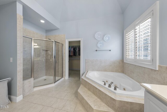 106 Painted Turtle Ln, Cary, NC 27519 - bathroom with a tub with jets, a stall shower, vanity, tile patterned flooring, and a walk in closet