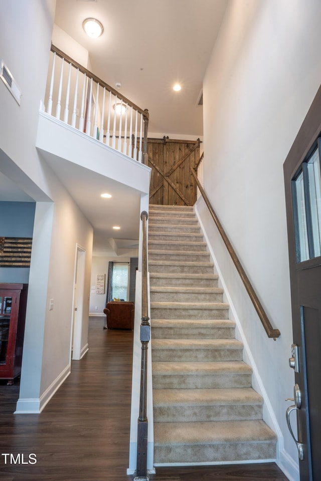 212 Hardwick St, Clayton, NC 27527 - stairs featuring a towering ceiling, wood finished floors, baseboards, and recessed lighting