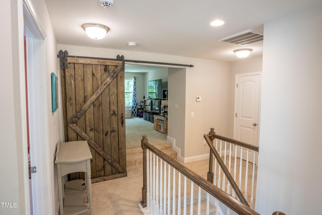 212 Hardwick St, Clayton, NC 27527 - corridor featuring light carpet, an upstairs landing, baseboards, a barn door, and recessed lighting